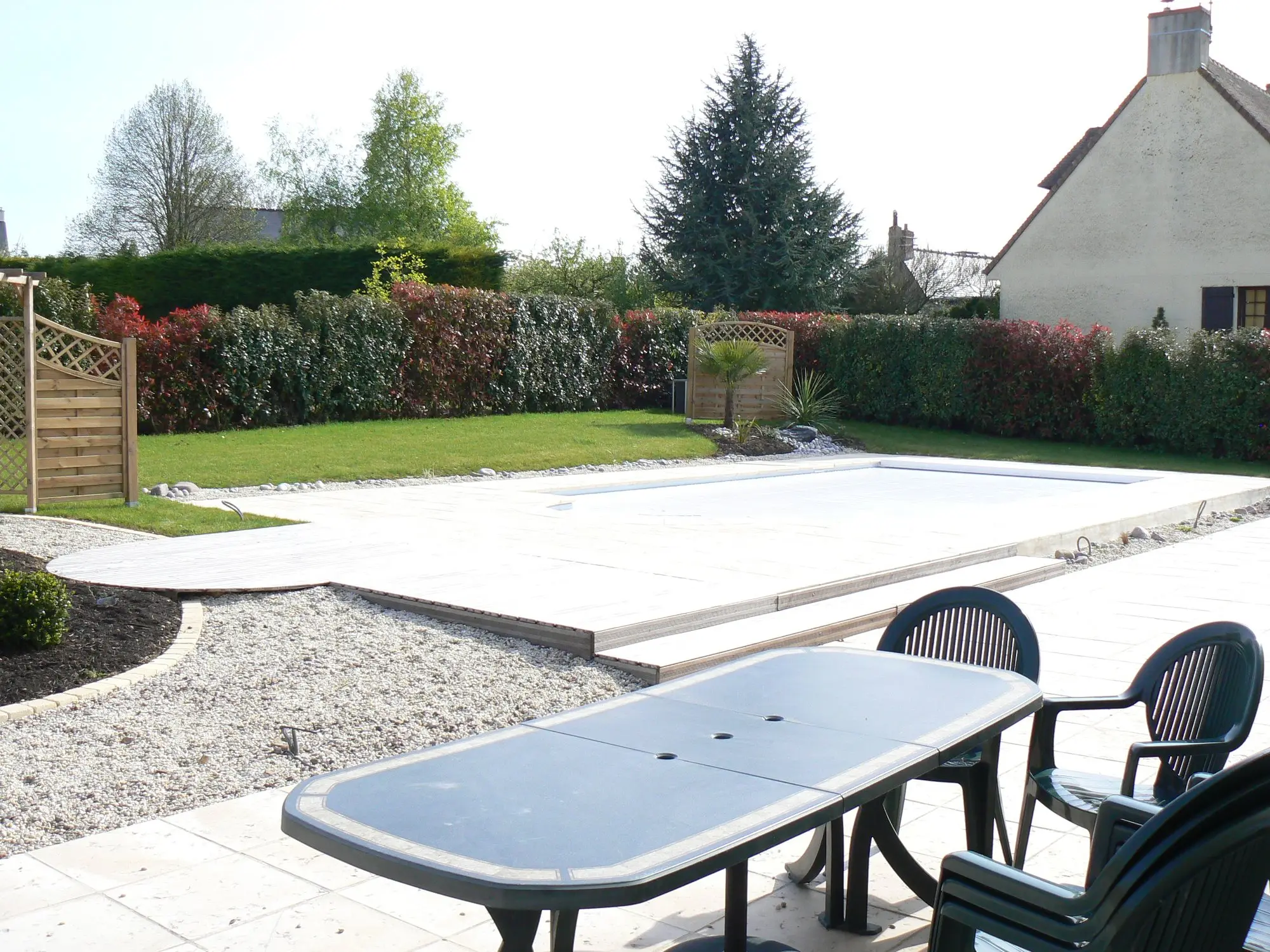 Finished swimming pool with terrace and furniture