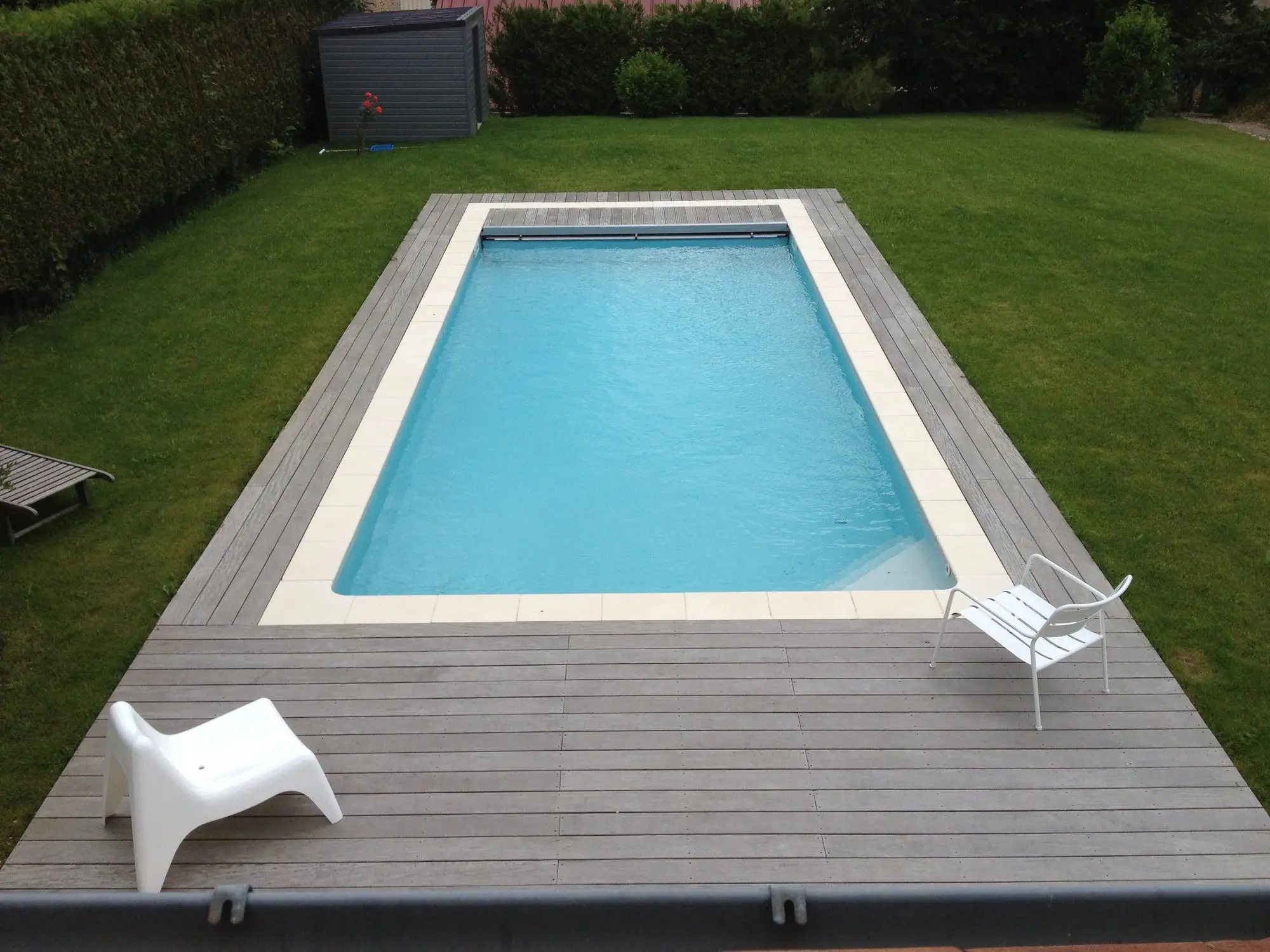 Pool with wooden deck and loungers